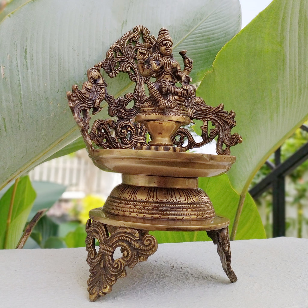 Majestic Brass Oil Lamp Of Goddess Lakshmi Crafted With Twin Peacocks. Height 34 cm x Width 22 cm X Depth 17 cm