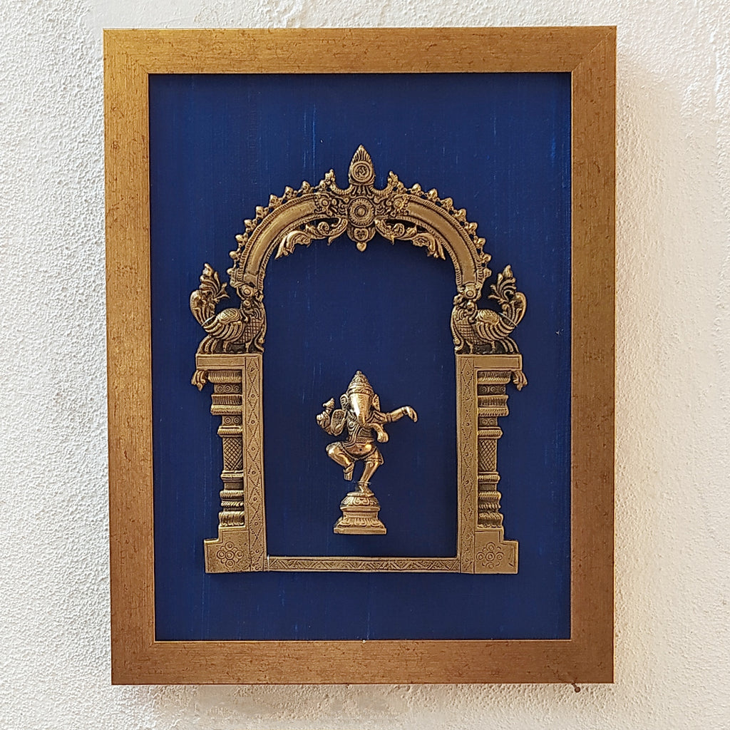 Divine Brass Prabhavali Framed On Deep Blue Raw Silk With Dancing Ganesha In Antique Gold Frame. Height 45 cm x Width 35 cm