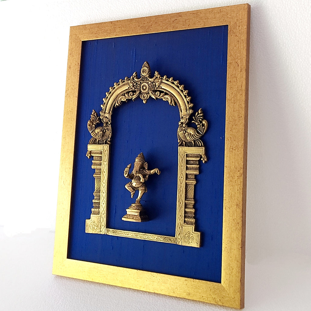 Divine Brass Prabhavali Framed On Deep Blue Raw Silk With Dancing Ganesha In Antique Gold Frame. Height 45 cm x Width 35 cm