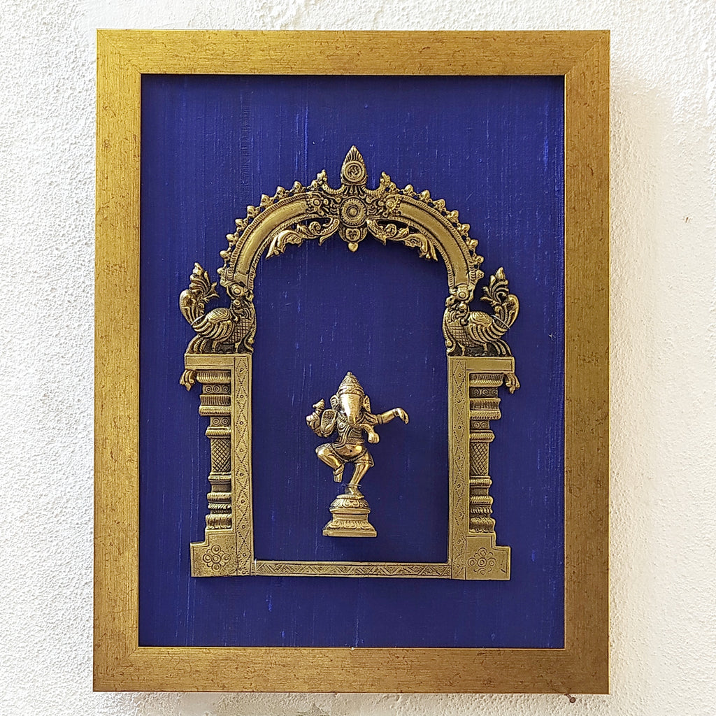 Divine Brass Prabhavali Framed On Deep Blue Raw Silk With Dancing Ganesha In Antique Gold Frame. Height 45 cm x Width 35 cm