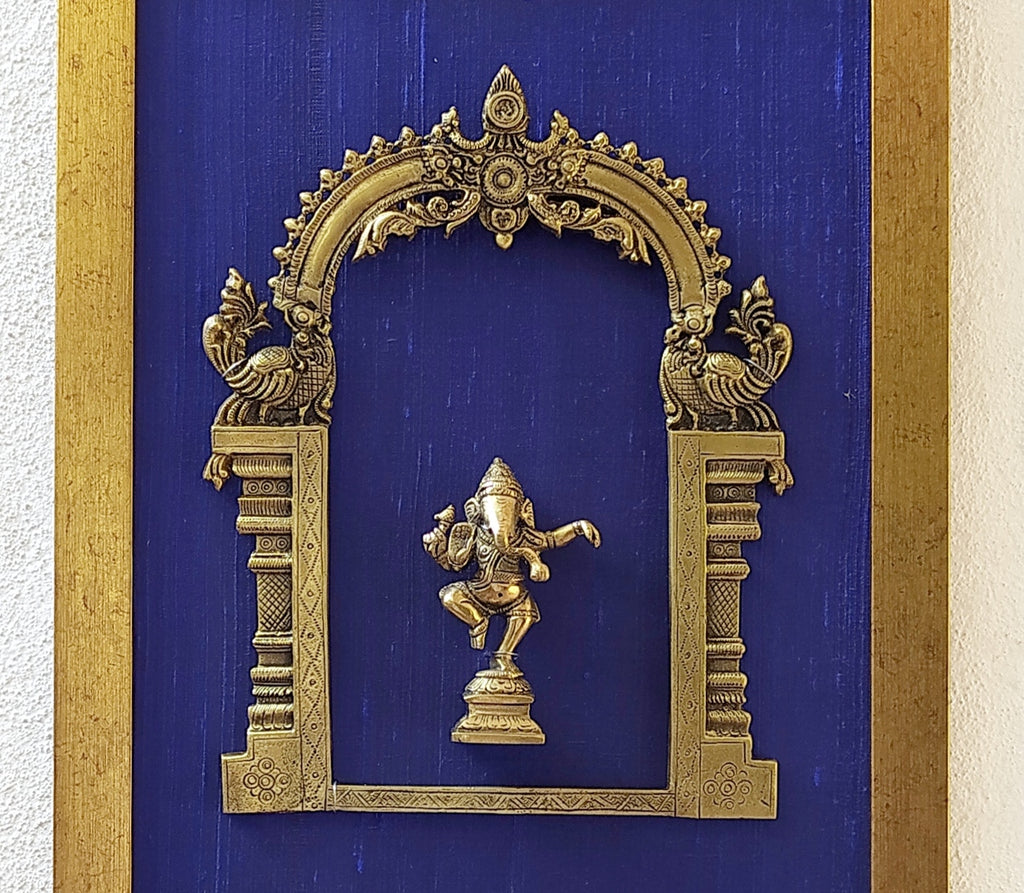 Divine Brass Prabhavali Framed On Deep Blue Raw Silk With Dancing Ganesha In Antique Gold Frame. Height 45 cm x Width 35 cm