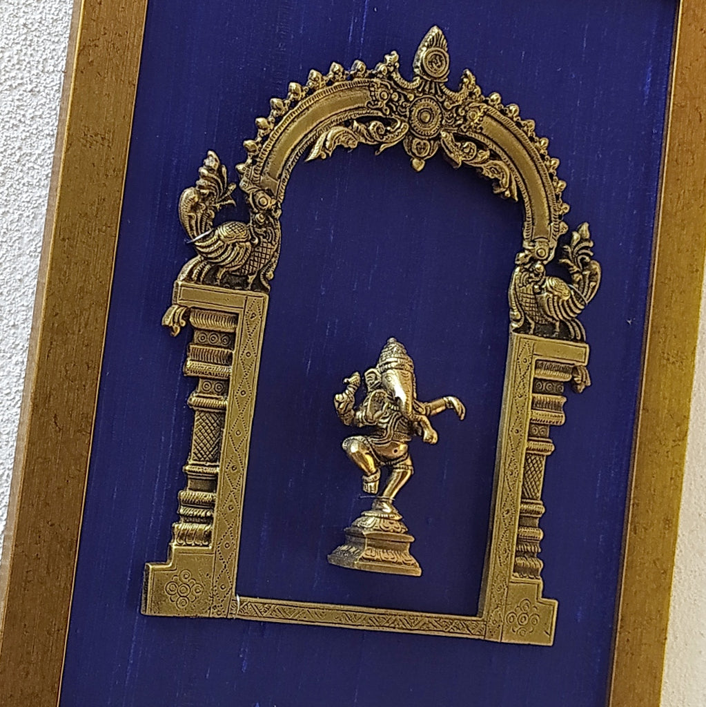 Divine Brass Prabhavali Framed On Deep Blue Raw Silk With Dancing Ganesha In Antique Gold Frame. Height 45 cm x Width 35 cm