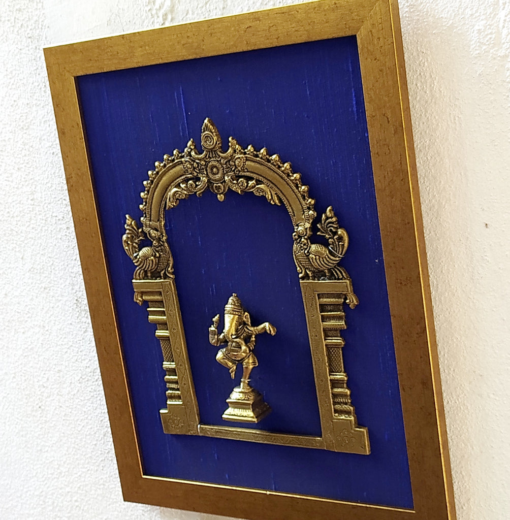 Divine Brass Prabhavali Framed On Deep Blue Raw Silk With Dancing Ganesha In Antique Gold Frame. Height 45 cm x Width 35 cm