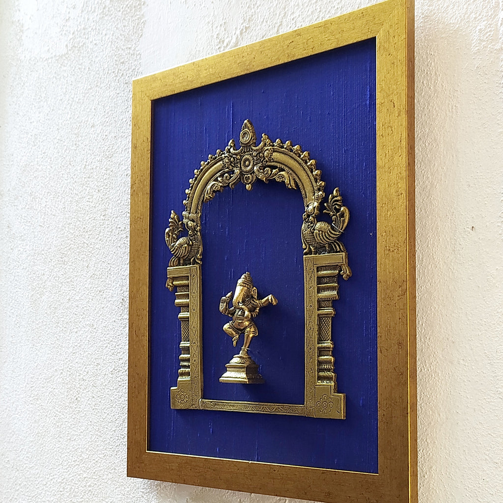 Divine Brass Prabhavali Framed On Deep Blue Raw Silk With Dancing Ganesha In Antique Gold Frame. Height 45 cm x Width 35 cm