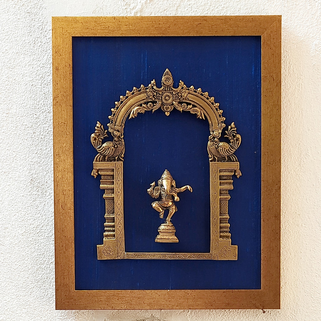 Divine Brass Prabhavali Framed On Deep Blue Raw Silk With Dancing Ganesha In Antique Gold Frame. Height 45 cm x Width 35 cm