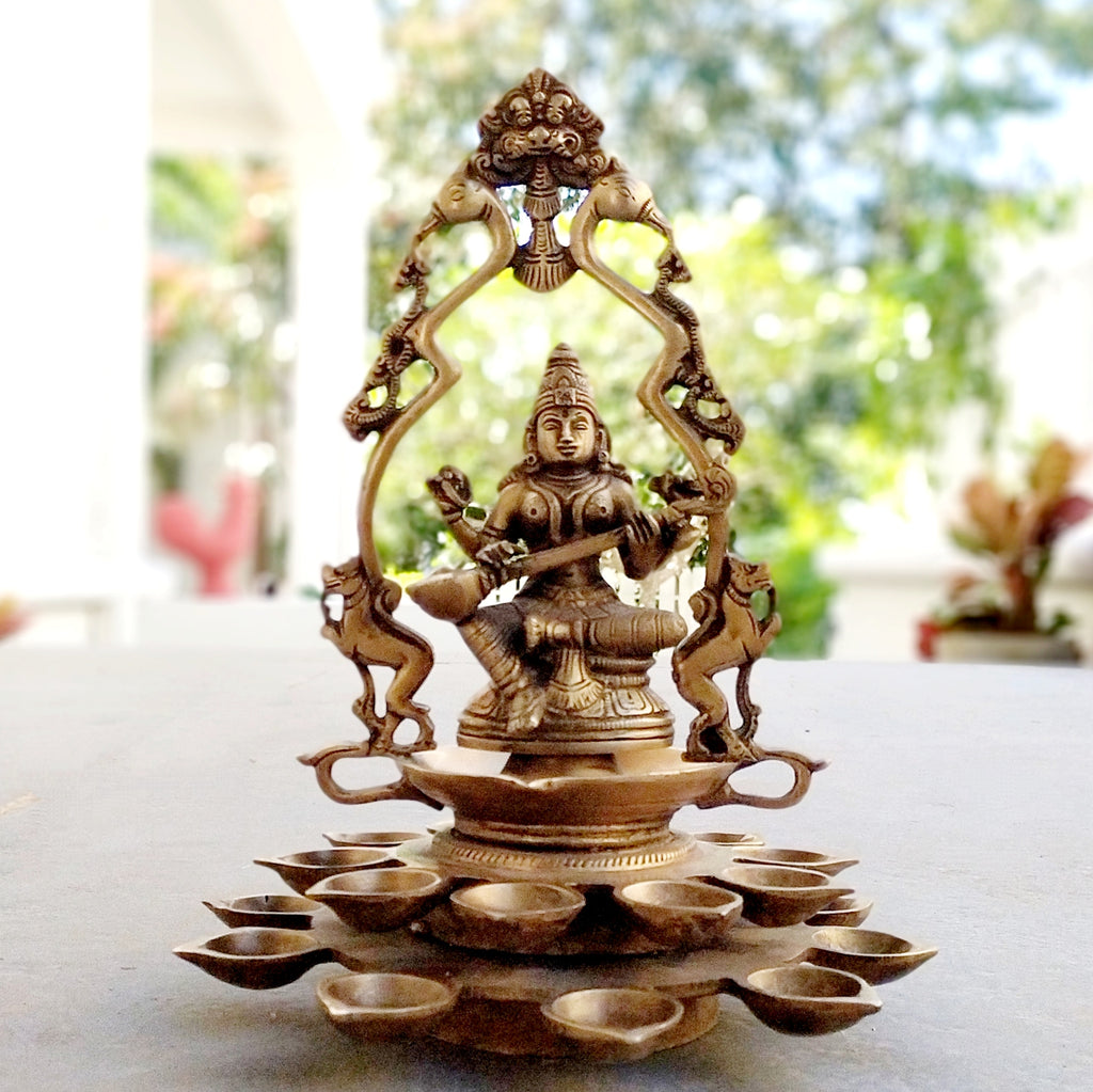 Brass Sculpture Of Saraswati - Goddess of Music, Art and Learning With 20 Diyas. Height 31 cm x Dia 24 cm