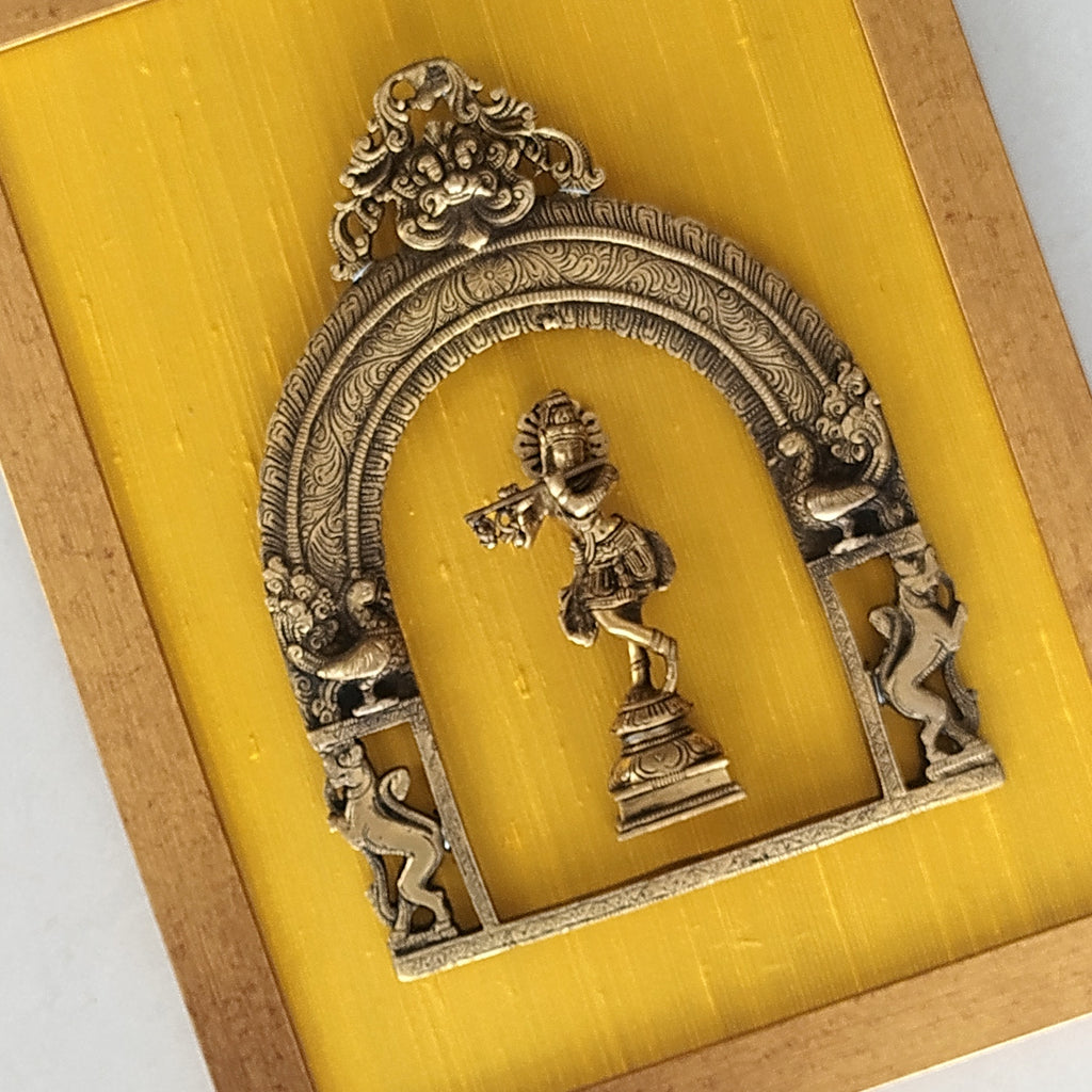 Divine Brass Prabhavali Framed On Gold Yellow Raw Silk With Lord Krishna. Frame Size: Height 45 cm x Width 35 cm