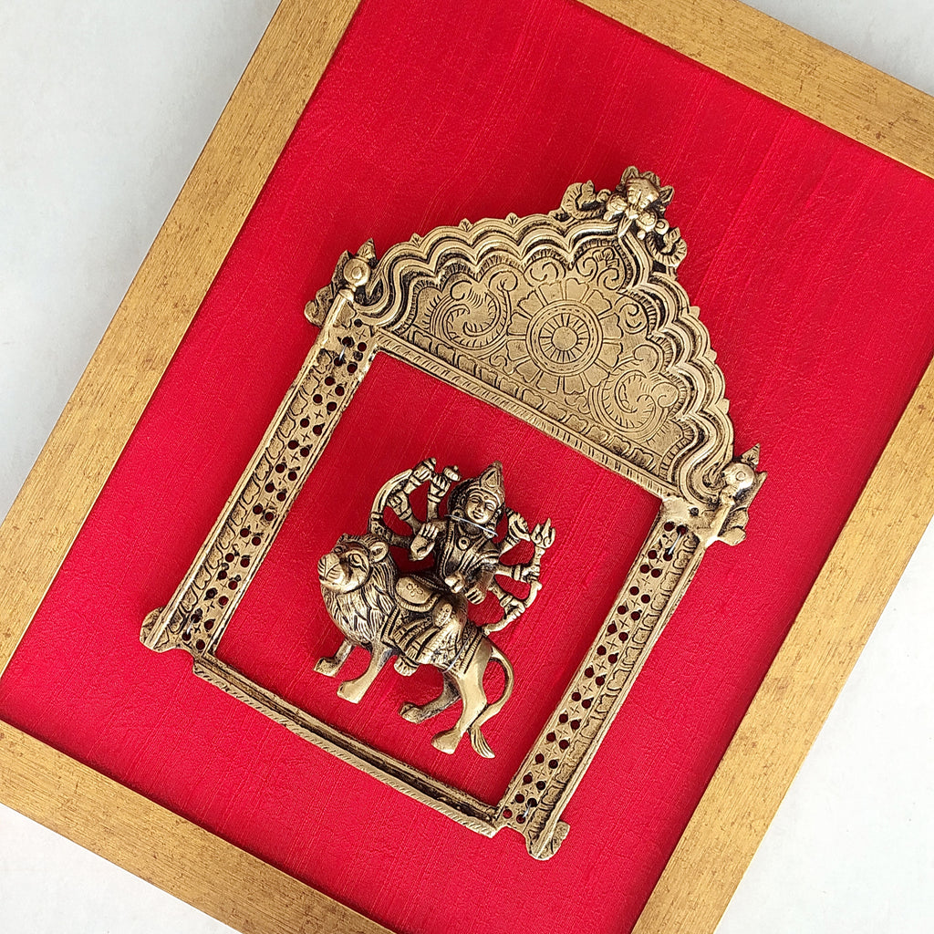 Majestic Brass Prabhavali With Goddess Durga Framed On Deep Red Raw Silk . Frame Height 45 cm x Width 35 cm