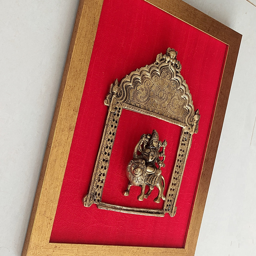 Majestic Brass Prabhavali With Goddess Durga Framed On Deep Red Raw Silk . Frame Height 45 cm x Width 35 cm